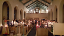 The congregation by candlelight